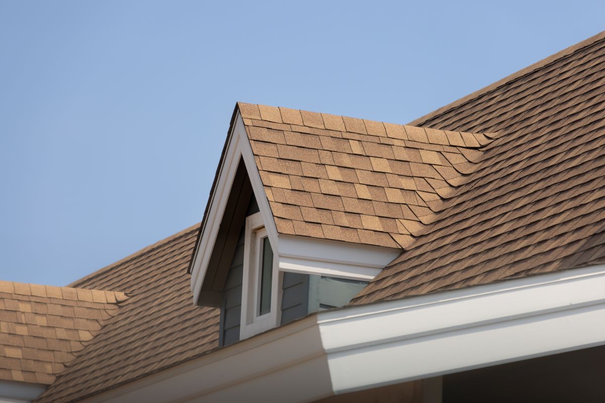 Roof shingles with garret house on top of the house, dark brown asphalt tiles on the roof, North Oaks, MN