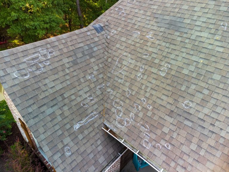 Roof with hail damage and markings from inspection in North Oaks