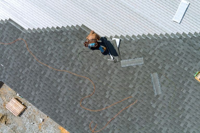 asphalt shingles installation on the roof roofer is nailing asphalt shingles to roofing construction, North Oaks