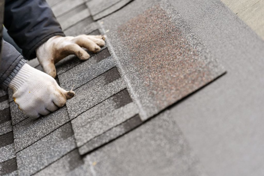 hand repairing shingle, North Oaks MN