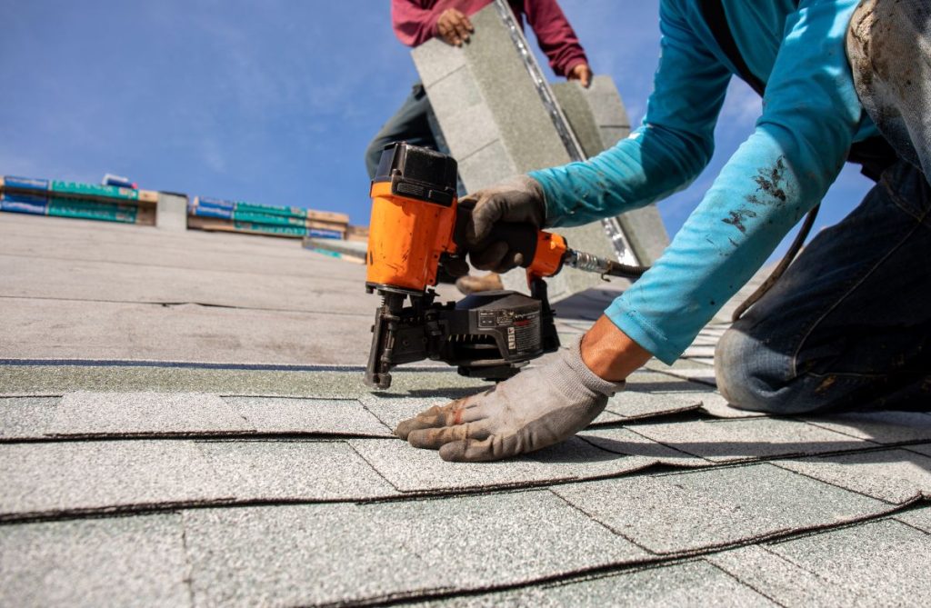 roofer installing roof shingles, North Oaks